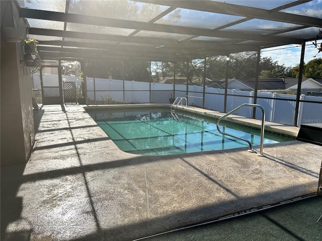 view of pool with a patio and glass enclosure