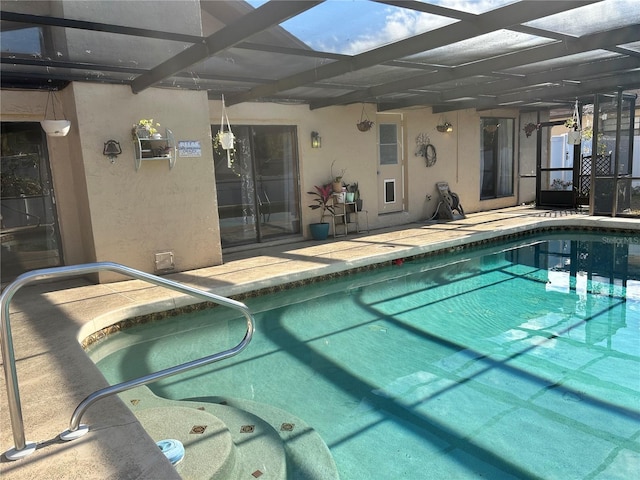 view of swimming pool with a lanai