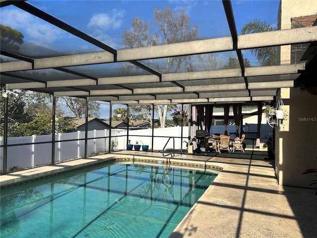 view of swimming pool featuring glass enclosure and a patio area