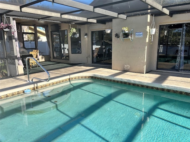 view of swimming pool featuring a lanai and a patio area