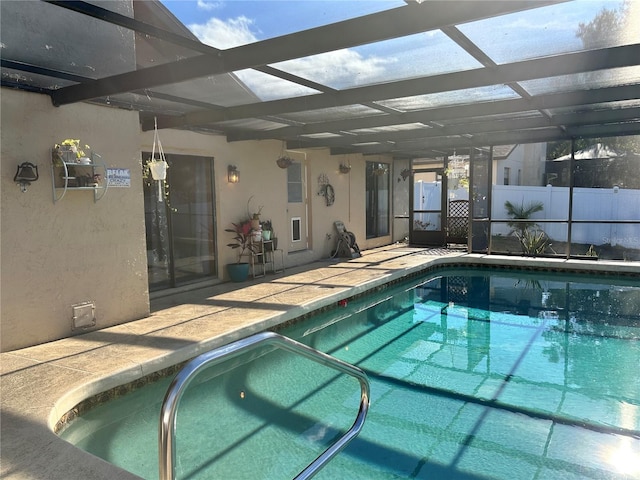 view of pool with glass enclosure