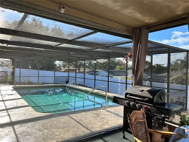 view of swimming pool with a patio, a lanai, and a grill