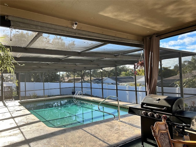 view of swimming pool with area for grilling, a lanai, and a patio