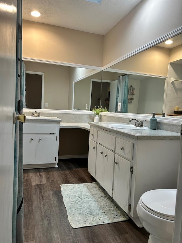 bathroom with vanity, hardwood / wood-style floors, and toilet