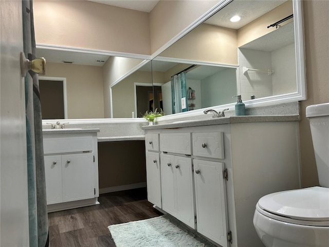 bathroom featuring hardwood / wood-style flooring, vanity, and toilet