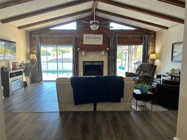 living room featuring dark hardwood / wood-style flooring, plenty of natural light, and a fireplace