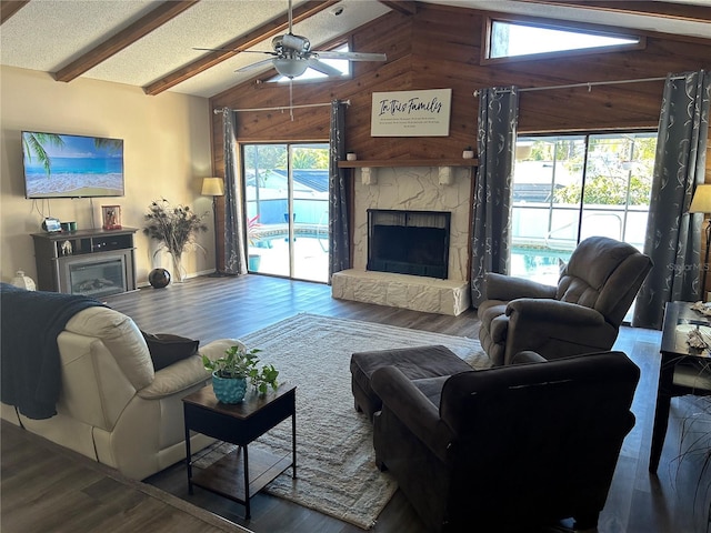 living room featuring wood-type flooring, a fireplace, lofted ceiling with beams, and wood walls