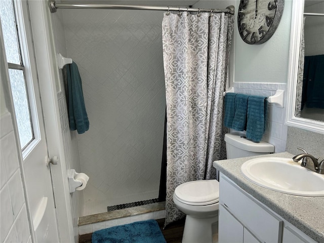 bathroom featuring vanity, toilet, and walk in shower