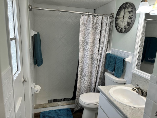 bathroom featuring walk in shower, vanity, and toilet