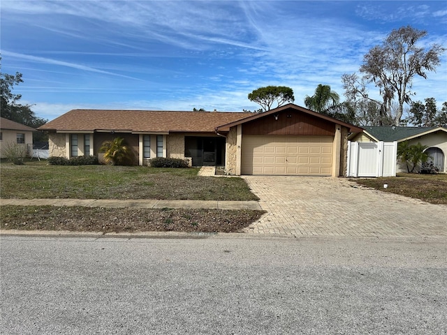 single story home with a garage and a front yard