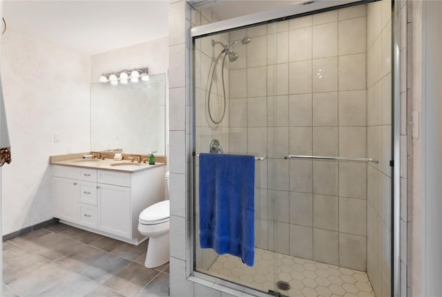 bathroom with vanity, an enclosed shower, and toilet