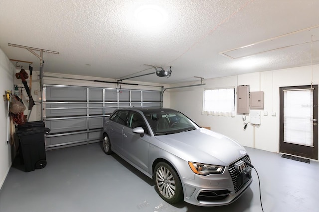 garage with a garage door opener and electric panel