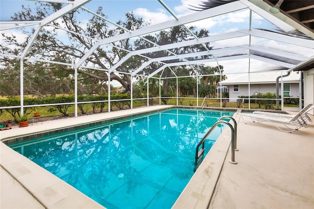 view of swimming pool featuring a lanai and a patio area