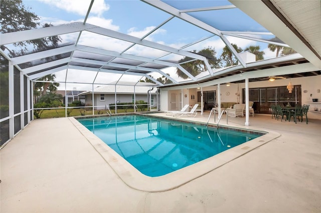 view of swimming pool with a patio and glass enclosure