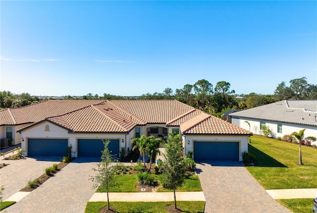 mediterranean / spanish-style home with a garage and a front lawn