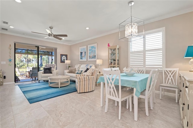 dining space featuring crown molding and ceiling fan with notable chandelier