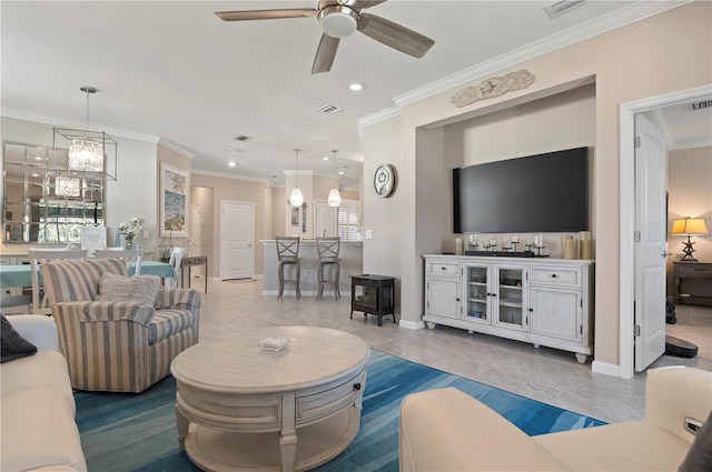 living room featuring ceiling fan with notable chandelier, plenty of natural light, and ornamental molding