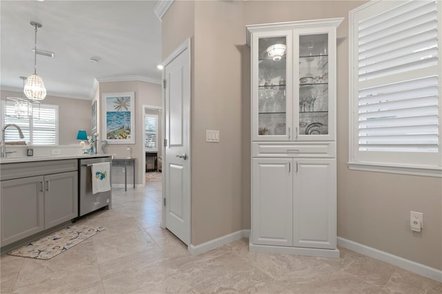 kitchen featuring sink, gray cabinetry, crown molding, decorative light fixtures, and dishwasher