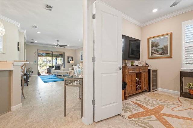 corridor featuring crown molding, light tile patterned floors, and beverage cooler