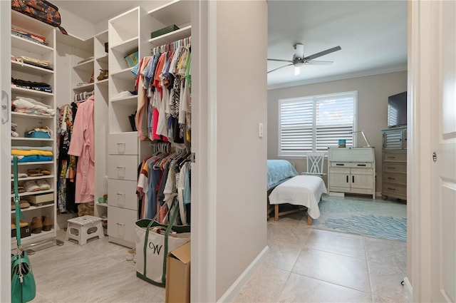 spacious closet featuring ceiling fan and light tile patterned floors