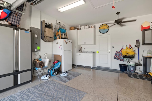 garage featuring electric panel and white fridge