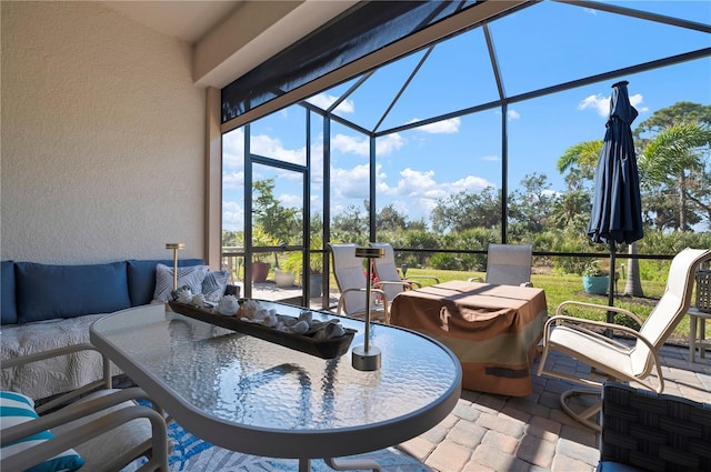 view of patio / terrace with an outdoor hangout area and glass enclosure