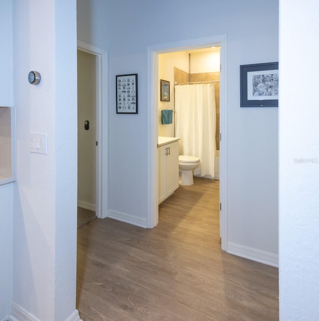 hallway with light hardwood / wood-style floors