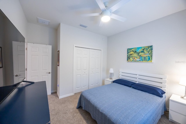 carpeted bedroom with a closet and ceiling fan