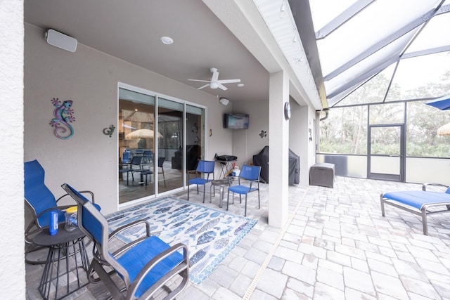 view of patio / terrace featuring a lanai, a grill, and ceiling fan