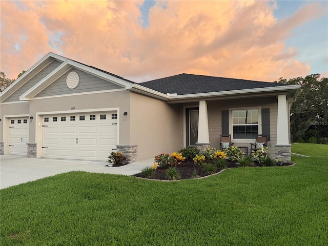 6614 162nd Pl E, Parrish, FL 34219 - view of front of house featuring a garage, a front lawn, concrete driveway, stucco siding, and stone siding