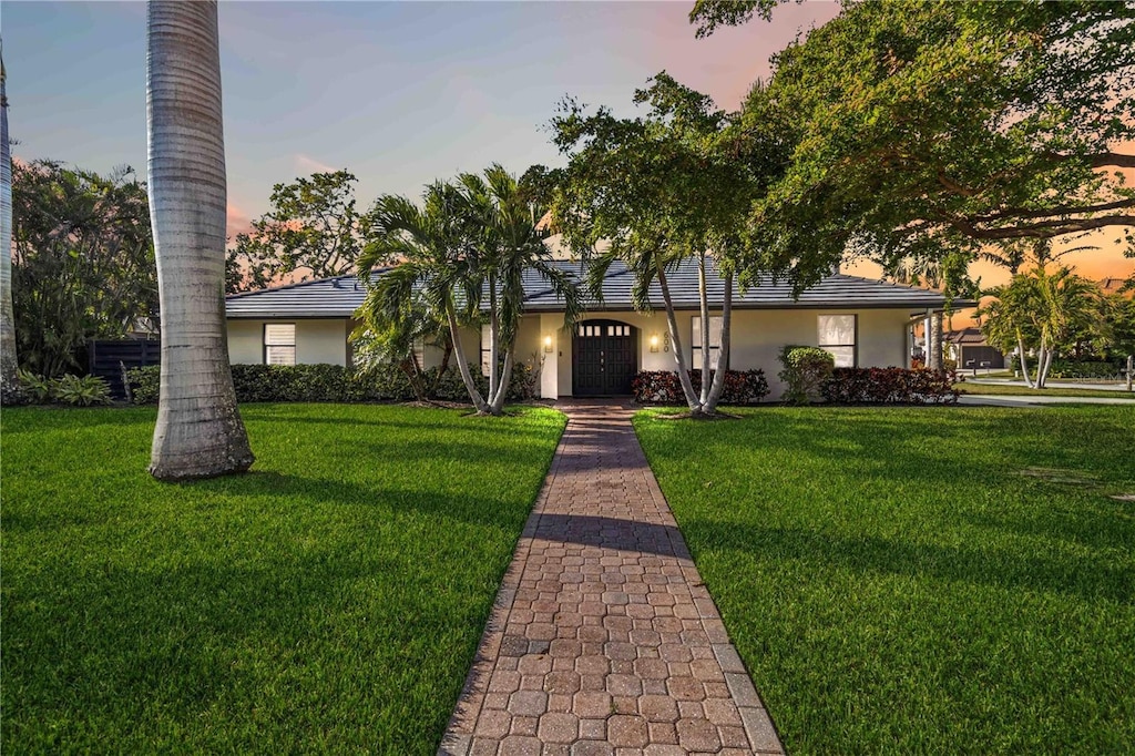 ranch-style house featuring a yard