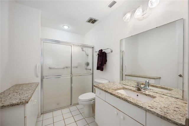 bathroom featuring vanity, tile patterned flooring, a shower with door, and toilet