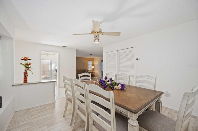 dining area featuring ceiling fan and light hardwood / wood-style floors