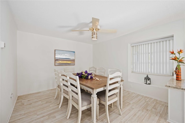 dining room with ceiling fan and light hardwood / wood-style flooring