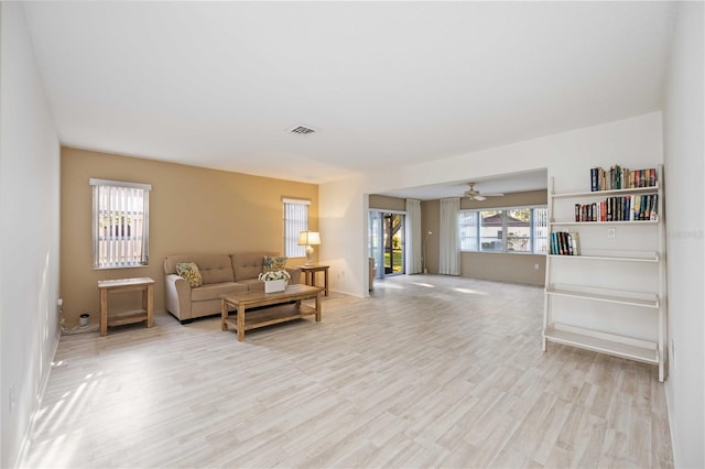 living room featuring ceiling fan and light wood-type flooring