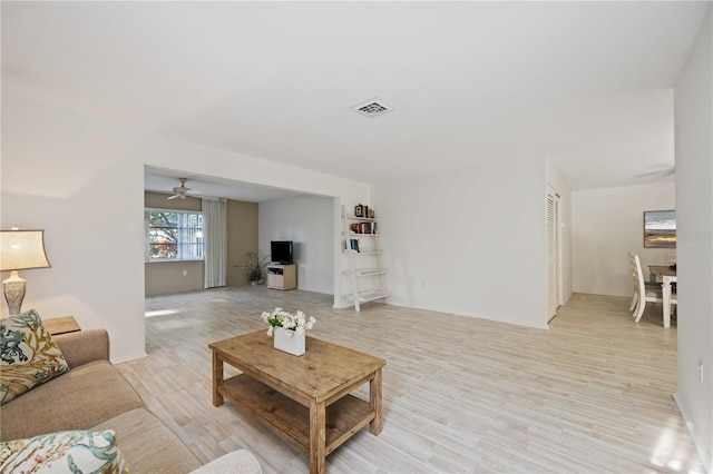 living room with ceiling fan and light wood-type flooring