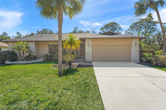 single story home featuring a garage and a front yard