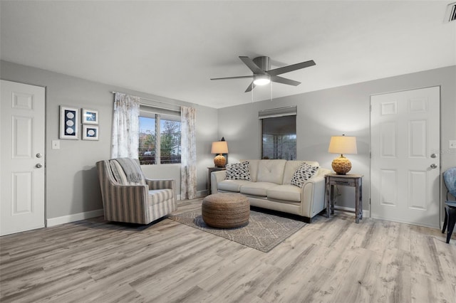 living room featuring ceiling fan and light hardwood / wood-style flooring