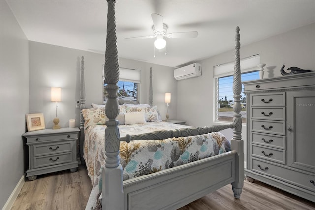 bedroom with wood-type flooring, a wall mounted air conditioner, and ceiling fan