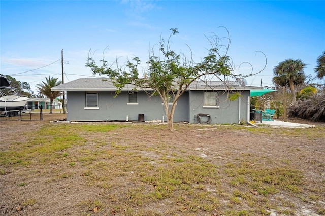 rear view of house featuring a yard