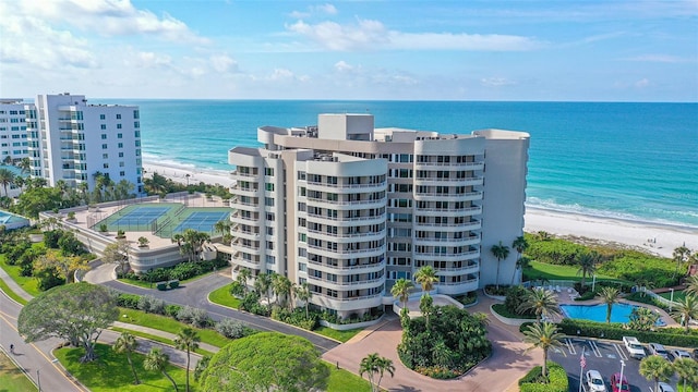 aerial view with a water view and a view of the beach