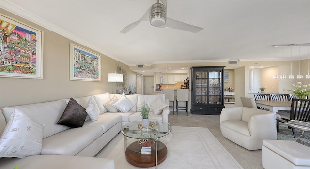 tiled living room featuring crown molding and ceiling fan