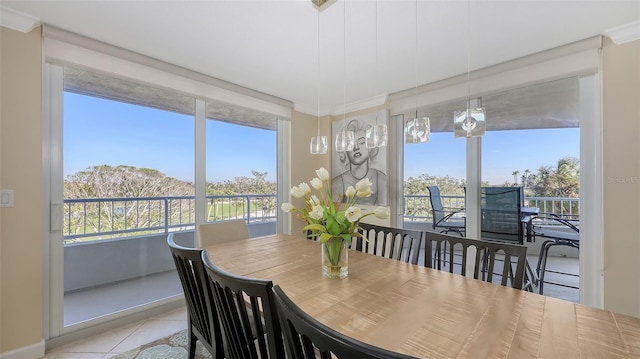 dining area with ornamental molding, plenty of natural light, and light tile patterned floors