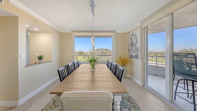 dining space featuring crown molding and light tile patterned flooring