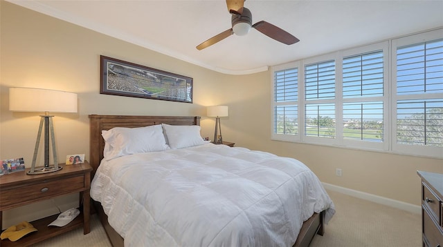 carpeted bedroom with crown molding and ceiling fan