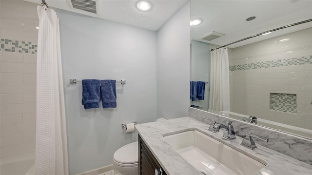 bathroom with vanity, walk in shower, and toilet