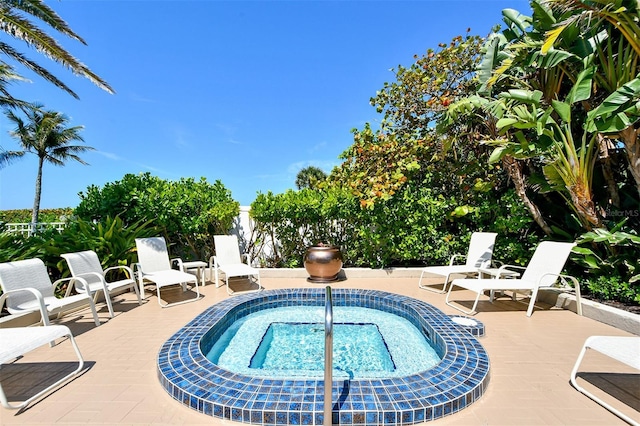 view of swimming pool with a hot tub and a patio area