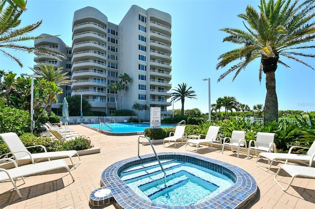 view of swimming pool with a community hot tub and a patio