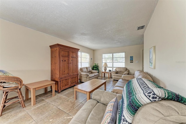 tiled living room with a textured ceiling