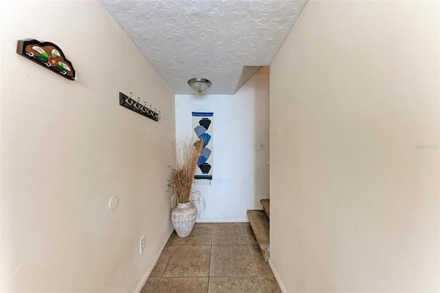 hallway with a textured ceiling